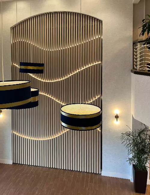 Illuminated wall art with wave-like slats