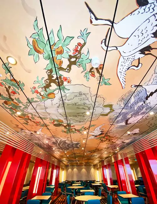 Ceiling art with vibrant cranes and foliage